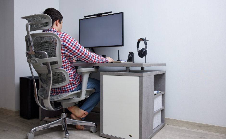 Ergonomic seating diagram showing correct monitor height, arm position, and knee angle for home office setup